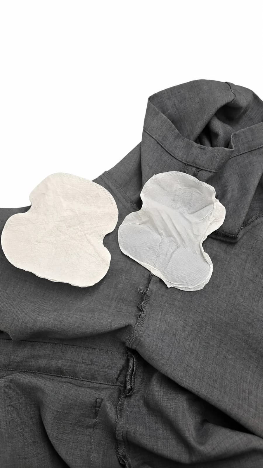 Example of an intact underarm sweat pad beside a pad that separated during removal from clothing