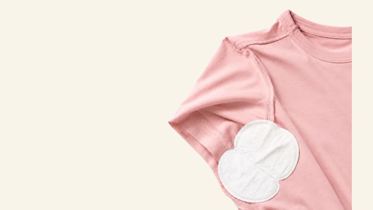 Underarm sweat pad attached inside a shirt